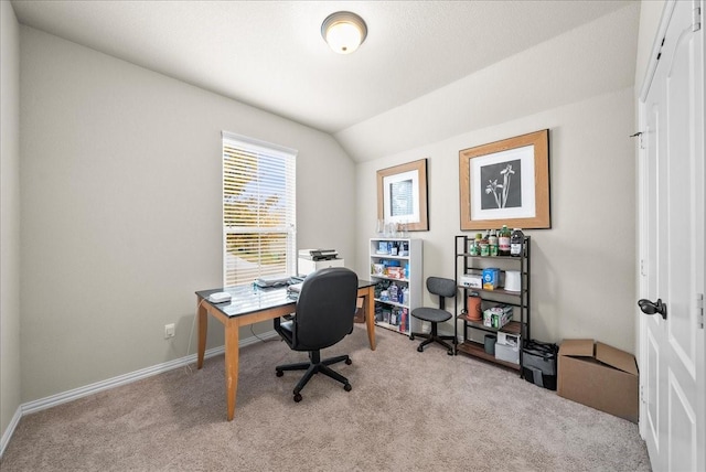 home office with light carpet and vaulted ceiling