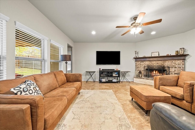 living room featuring ceiling fan and a fireplace