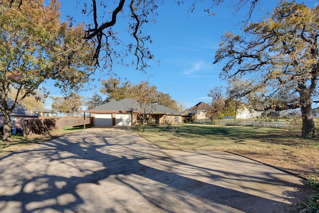 view of front of property featuring a garage and a front lawn