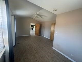 unfurnished room with ceiling fan, dark hardwood / wood-style flooring, and vaulted ceiling