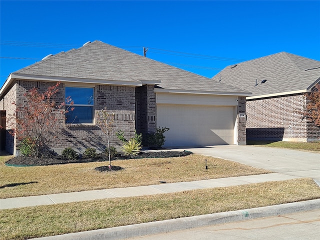 single story home featuring a garage and a front lawn