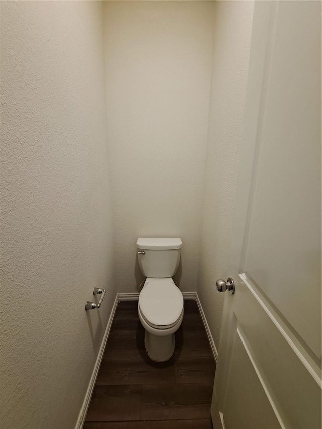 bathroom featuring hardwood / wood-style floors and toilet