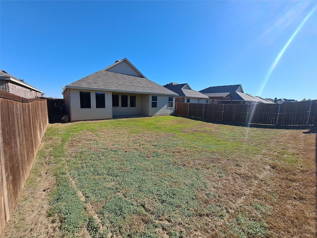 back of house with a lawn