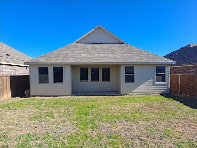 back of house featuring a patio and a lawn