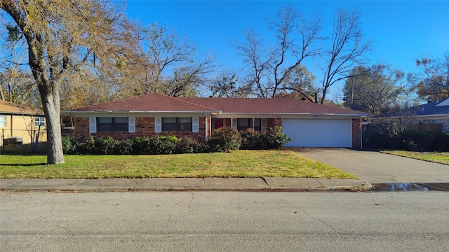 single story home with a garage and a front yard