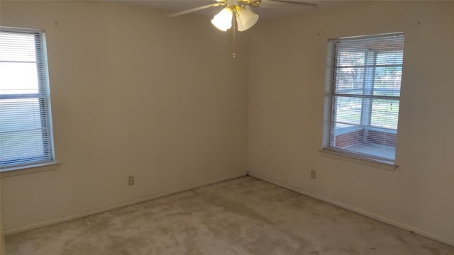 carpeted spare room with ceiling fan