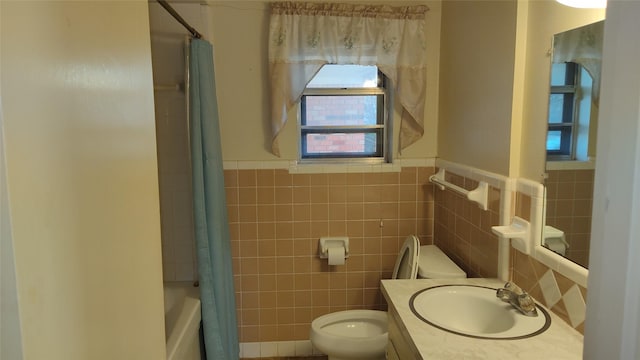 full bathroom with vanity, tile walls, shower / bathtub combination with curtain, and toilet