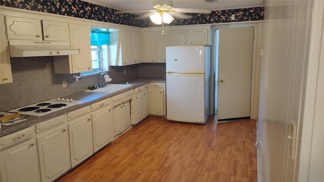 kitchen featuring tasteful backsplash, white appliances, ceiling fan, sink, and light hardwood / wood-style flooring