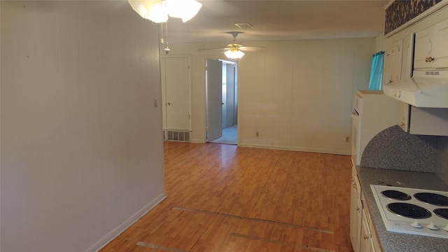 kitchen featuring white electric stovetop, white cabinets, ceiling fan, and light hardwood / wood-style flooring