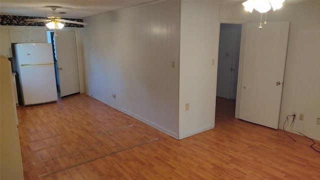 spare room with light wood-type flooring and ceiling fan