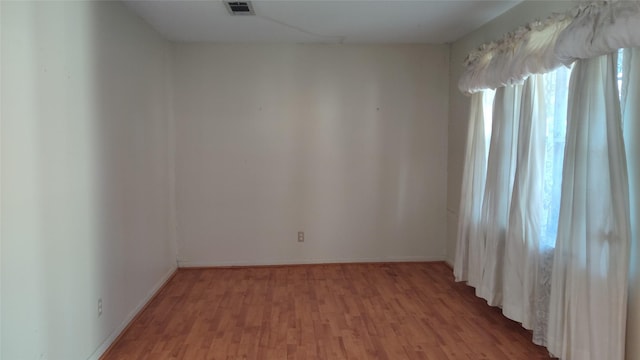 spare room with light hardwood / wood-style flooring