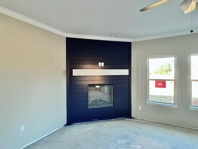 unfurnished living room with ceiling fan, a large fireplace, and ornamental molding