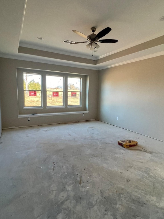 empty room with a raised ceiling, ceiling fan, and crown molding