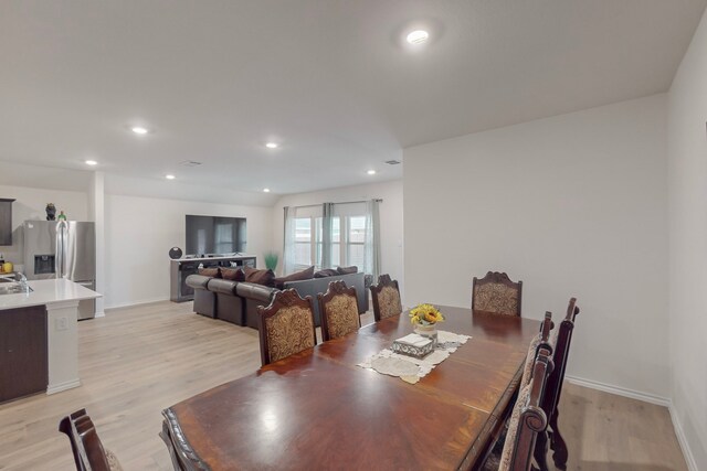 dining space featuring light wood-type flooring