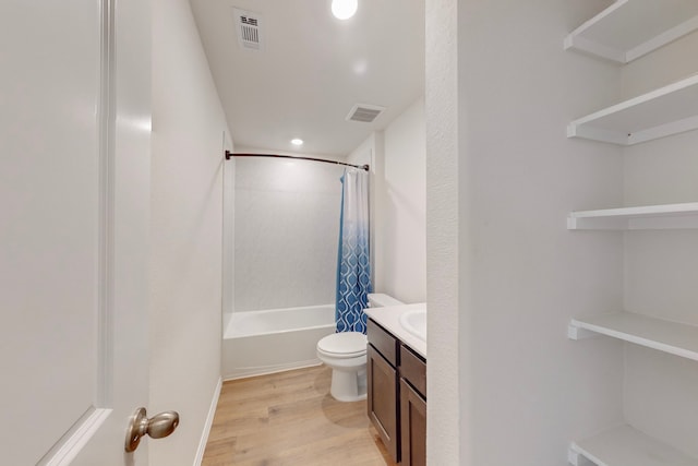 full bathroom with hardwood / wood-style floors, vanity, toilet, and shower / tub combo with curtain