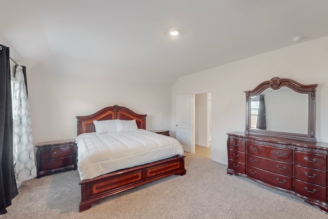 carpeted bedroom featuring lofted ceiling