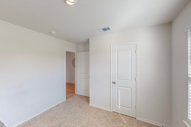 unfurnished bedroom with light carpet