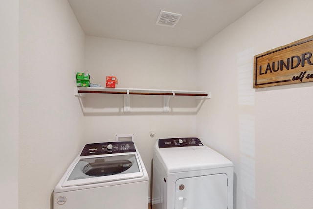 washroom with independent washer and dryer