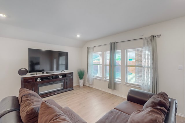 living room featuring light hardwood / wood-style floors and vaulted ceiling