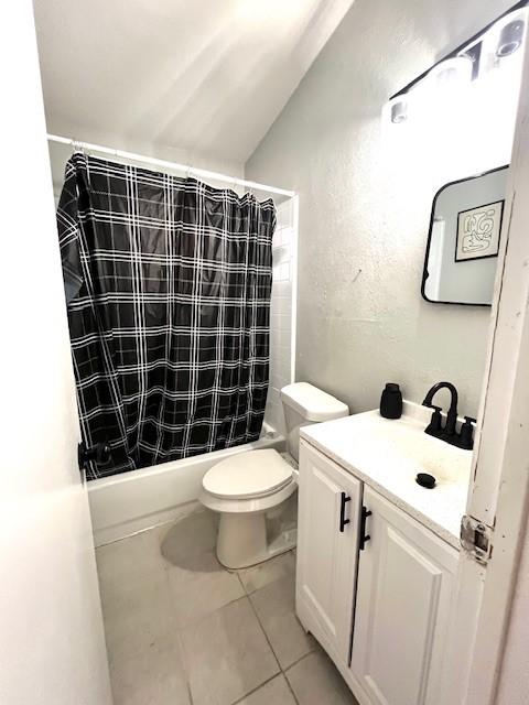 full bathroom with vanity, tile patterned floors, toilet, and shower / tub combo with curtain