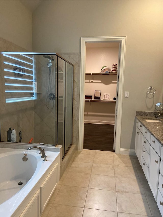 bathroom with tile patterned floors, vanity, and independent shower and bath