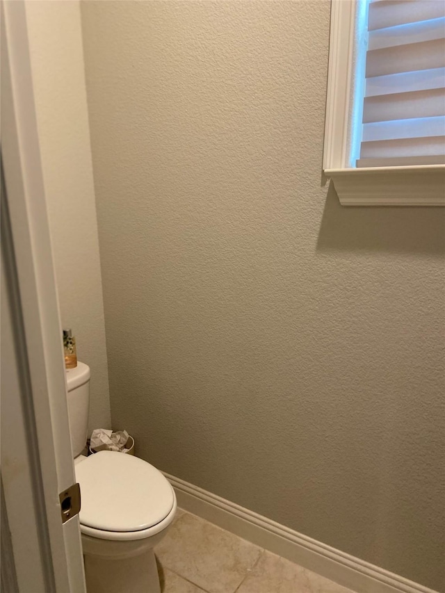 bathroom featuring tile patterned floors and toilet