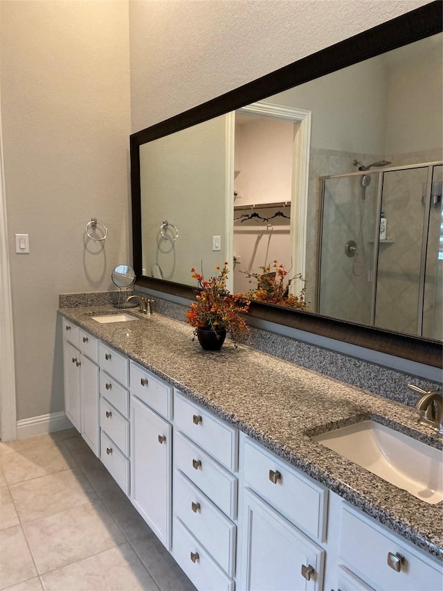 bathroom with vanity, tile patterned floors, and walk in shower