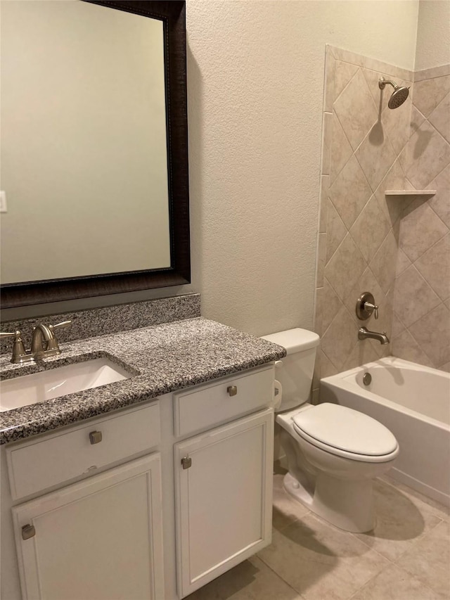 full bathroom featuring tile patterned flooring, vanity, toilet, and tiled shower / bath combo