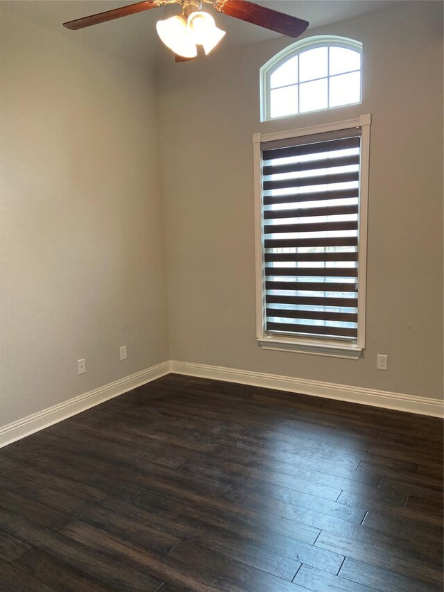 spare room with ceiling fan and dark hardwood / wood-style floors