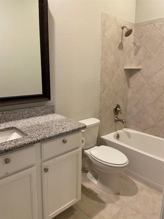 full bathroom with tile patterned flooring, vanity, toilet, and tiled shower / bath combo