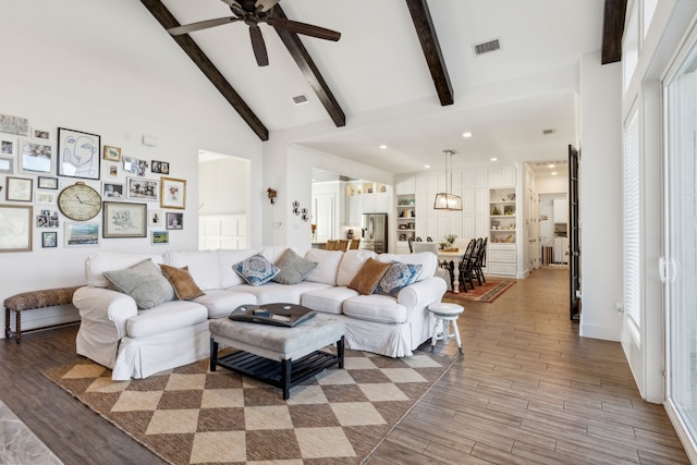 living room featuring hardwood / wood-style flooring, ceiling fan, beam ceiling, and high vaulted ceiling