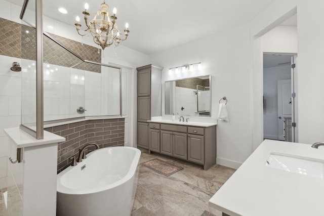 bathroom with separate shower and tub, vanity, and an inviting chandelier