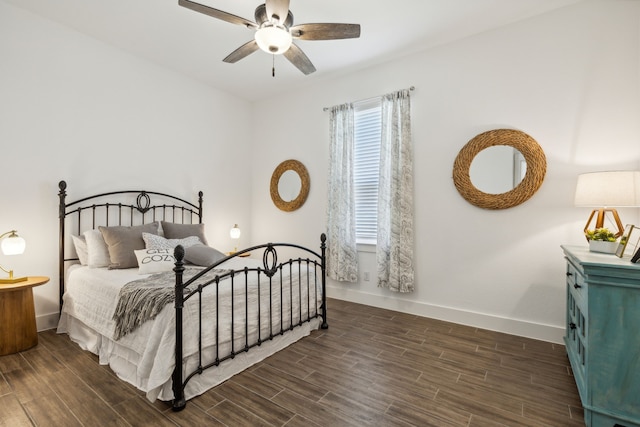 bedroom with dark hardwood / wood-style flooring and ceiling fan