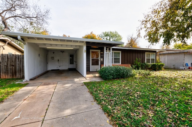 ranch-style house with a front lawn and a carport