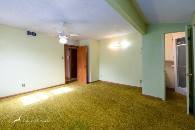 empty room with a textured ceiling, vaulted ceiling with beams, carpet floors, and ceiling fan