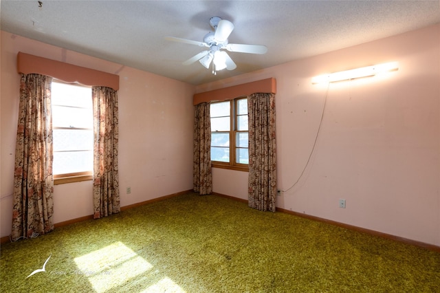 carpeted empty room featuring a textured ceiling and ceiling fan