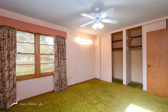 unfurnished bedroom with carpet, ceiling fan, and a textured ceiling