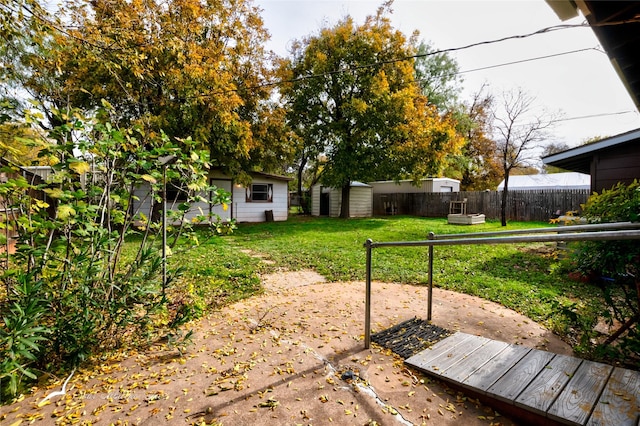 view of yard with a storage unit and a patio area