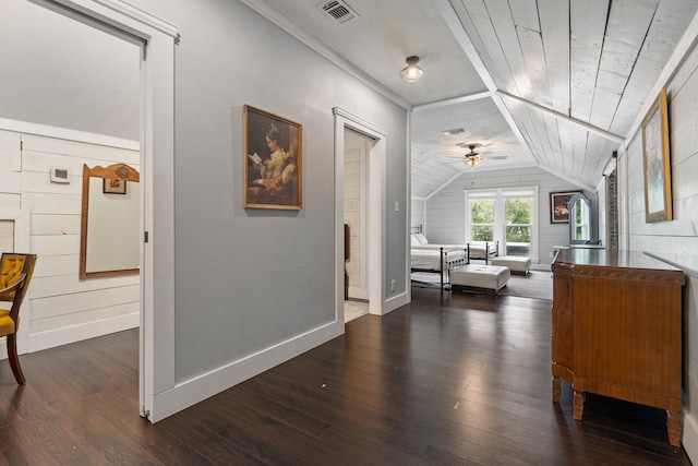 hall featuring wood walls, lofted ceiling, wooden ceiling, crown molding, and dark hardwood / wood-style flooring