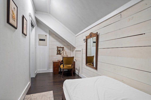 bedroom with wooden walls, dark hardwood / wood-style floors, and lofted ceiling