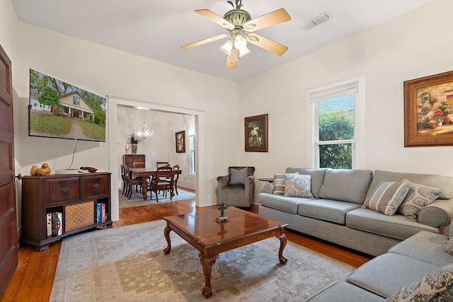 living room with light hardwood / wood-style flooring and ceiling fan