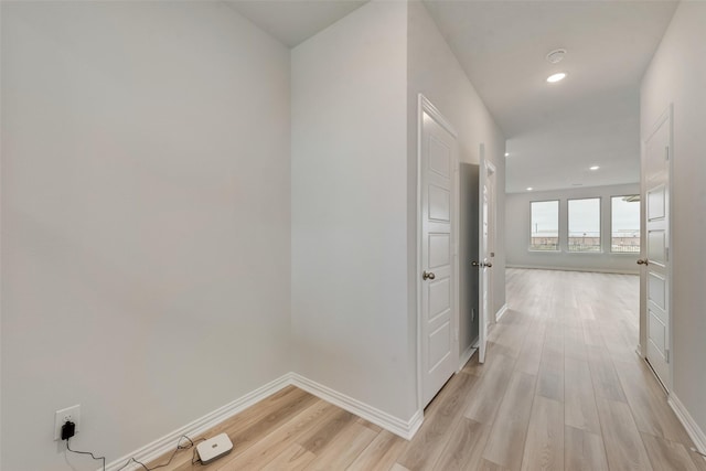 hallway with light hardwood / wood-style flooring