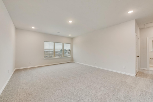 unfurnished room with light colored carpet