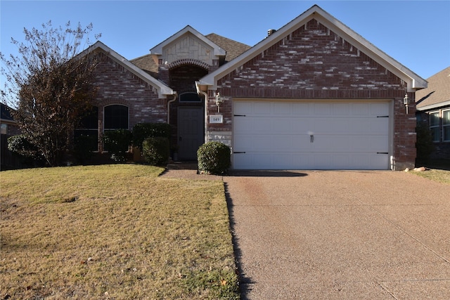 view of front of home with a garage and a front yard