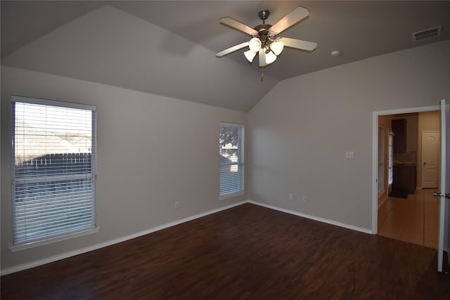 empty room featuring ceiling fan, lofted ceiling, and dark hardwood / wood-style flooring