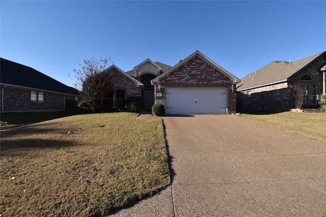 view of front of property with a garage and a front yard