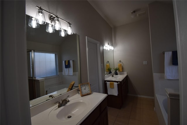 bathroom with vanity, a bathing tub, and tile patterned flooring