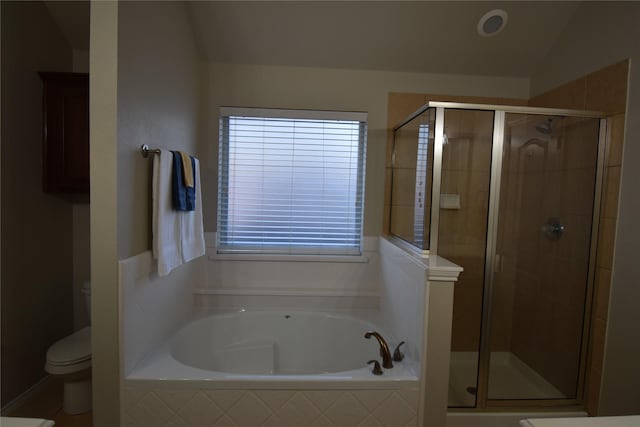 bathroom featuring toilet and shower with separate bathtub