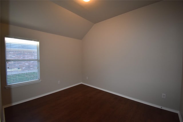 empty room featuring hardwood / wood-style flooring and vaulted ceiling