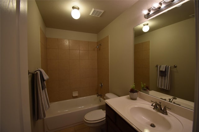 full bathroom featuring vanity, tiled shower / bath, tile patterned flooring, and toilet